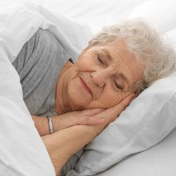 Close-up of senior woman sleeping in bed